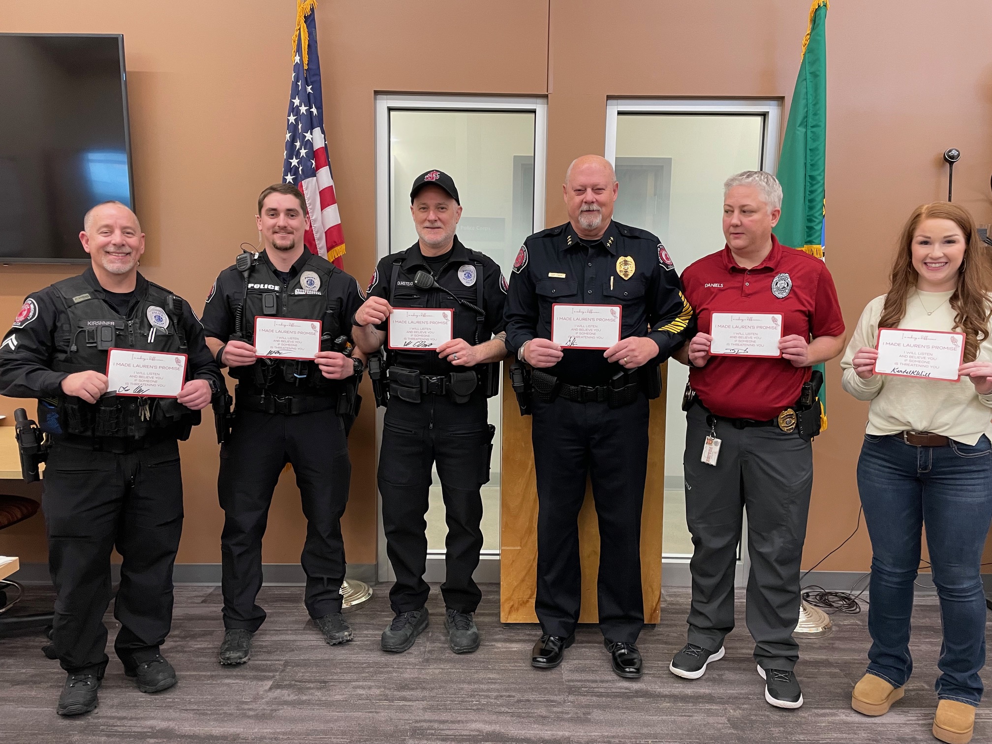 Washington State University Police holding signed "Lauren's Promise" cards: I will listen and believe you, if you are being threatened."